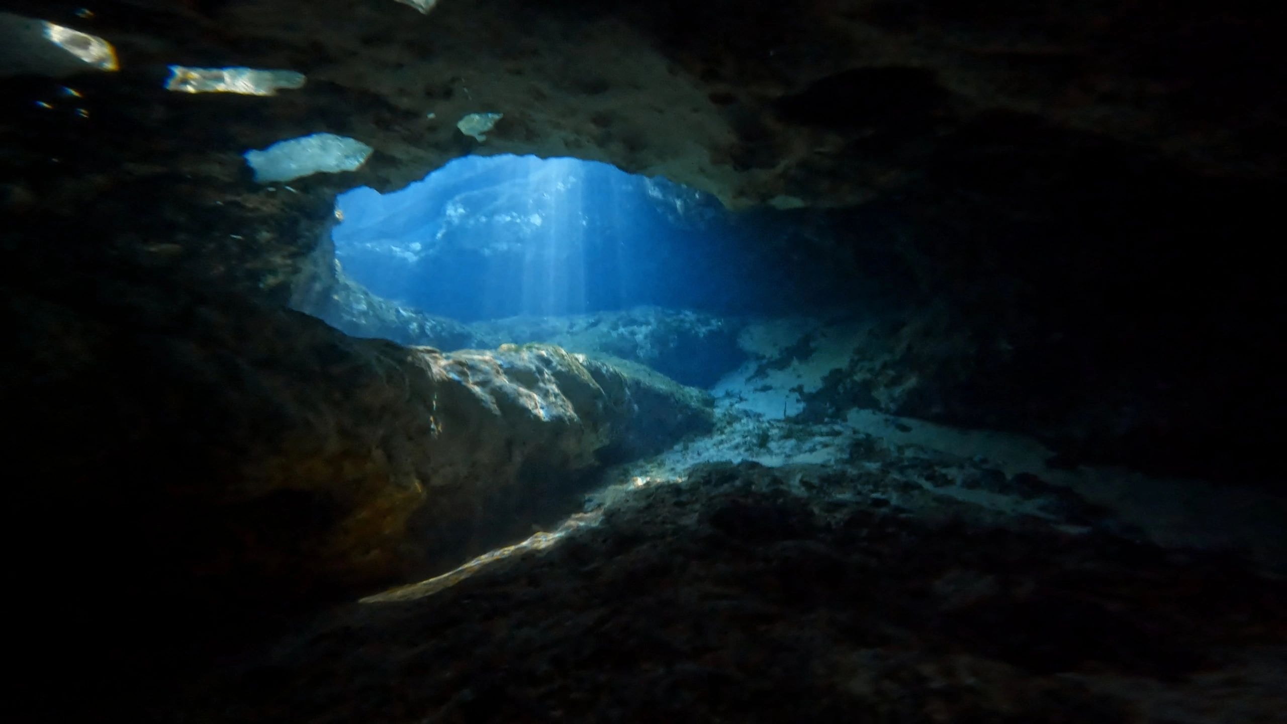 Dramatic underwater cave with light rays