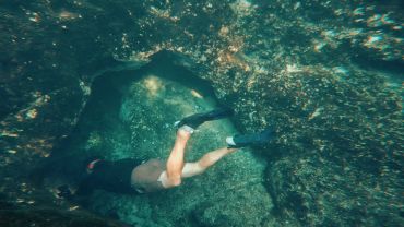Overhead view of snorkeler in turquoise water